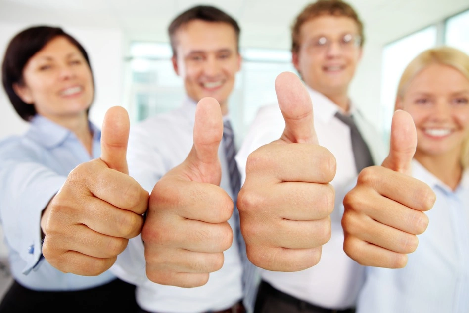 Business team thumbs up.